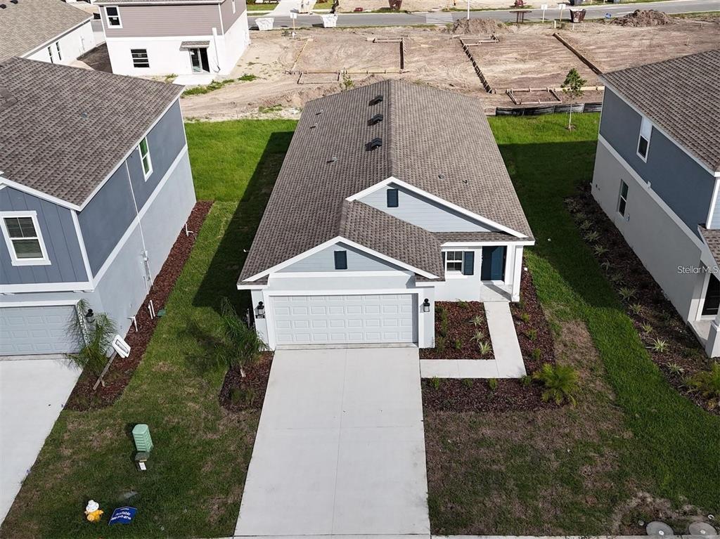 An aerial view shows a single-story house with a two-car garage and gray siding — 602 BELL PRAIRIE CIRCLE, LAKE WALES, FL