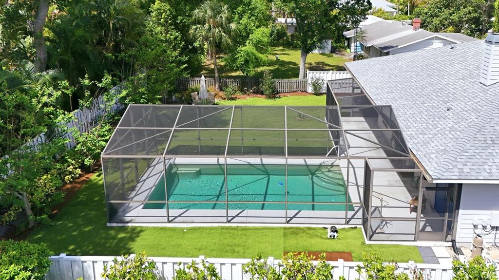 An aerial view of a backyard featuring a swimming pool enclosed by a screened lanai — 1714 WALDEMERE STREET, SARASOTA, FL