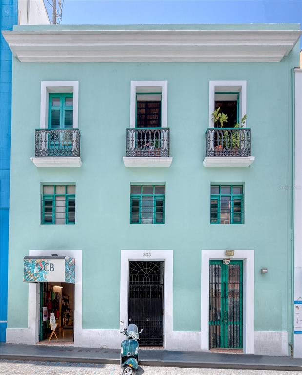 A three-story, light blue building features a storefront, two entrances, and three upper-level balconies — 203 FORTALEZA STREET UNIT 4, SAN JUAN, PR