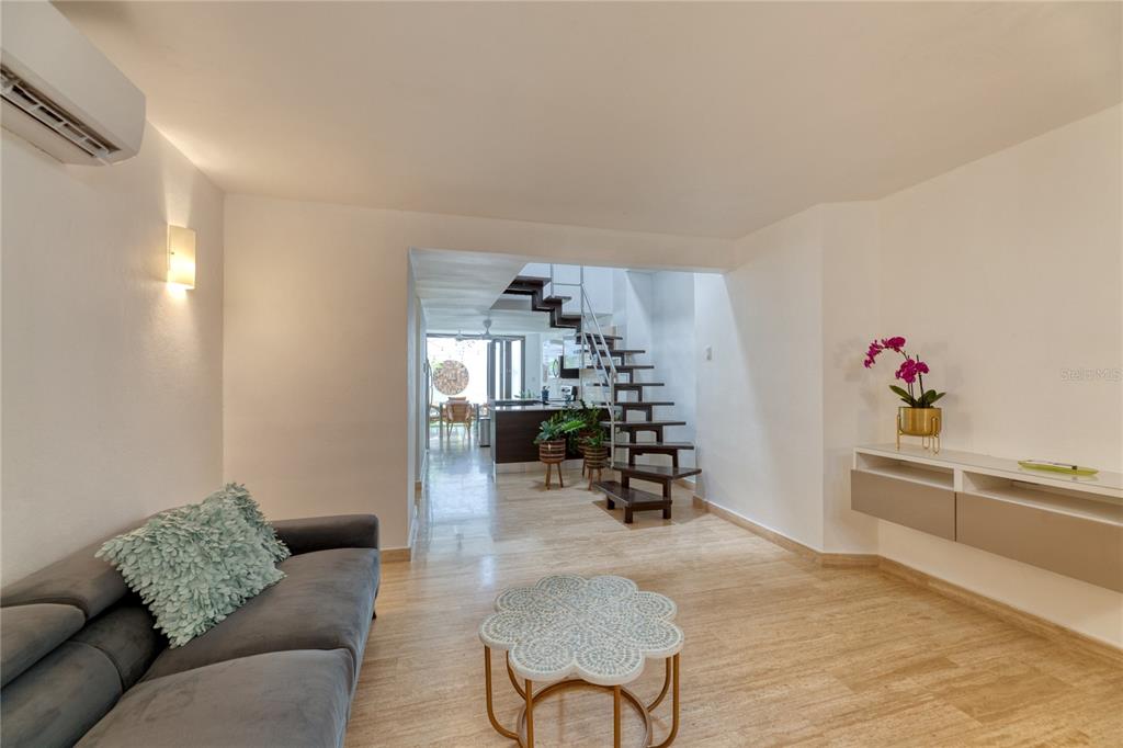 A living room with a grey sofa, a flower-shaped coffee table, and an open staircase — 203 FORTALEZA STREET UNIT 4, SAN JUAN, PR