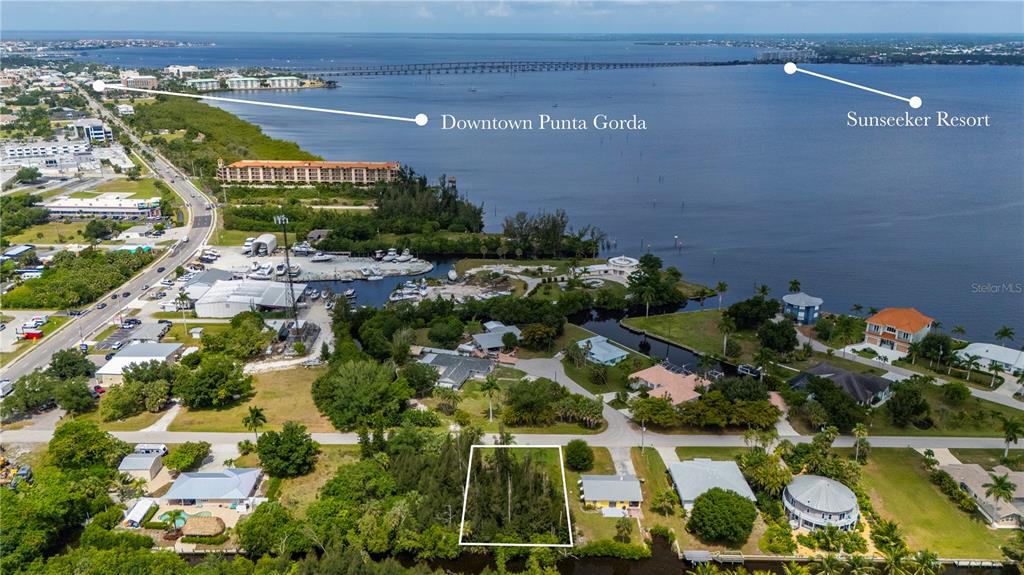 This aerial view shows a vacant, wooded residential lot near a waterfront area — 430 KLISPIE DRIVE, PUNTA GORDA, FL