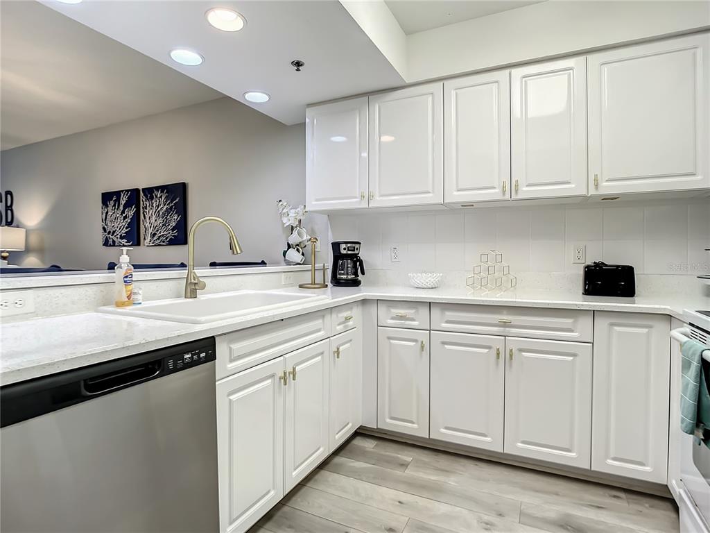 A kitchen with white cabinets, stainless steel appliances, and light-colored countertops — 5300 S ATLANTIC AVENUE UNIT 10-205, NEW SMYRNA BEACH, FL