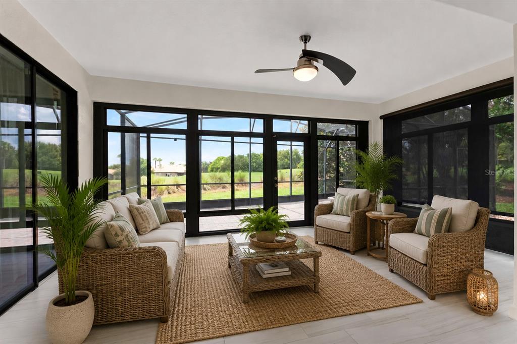 A sunroom features wicker furniture, a ceiling fan, and large windows overlooking a grassy yard — 8972 DOVE VALLEY WAY, DAVENPORT, FL