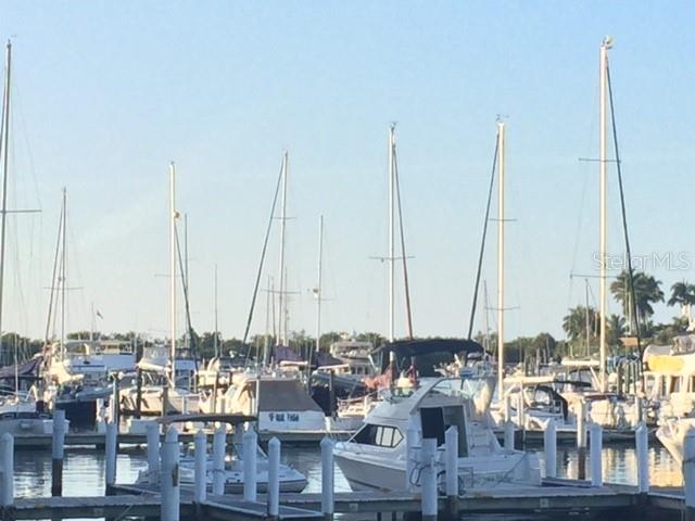 A marina filled with various sailboats and motorboats docked at wooden piers — 801 ISLAMORADA BOULEVARD UNIT 25B, PUNTA GORDA, FL
