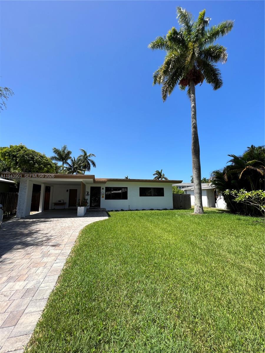 A single-story white house features a paved driveway, a front porch, and a tall palm tree — 1425 Grant St, Hollywood FL 33020, HOLLYWOOD, FL