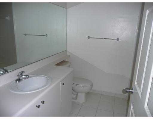A bathroom with a white vanity, a single sink, a large mirror, and a toilet — 2160 E Preserve Way # 201, Miramar FL 33025, MIRAMAR, FL