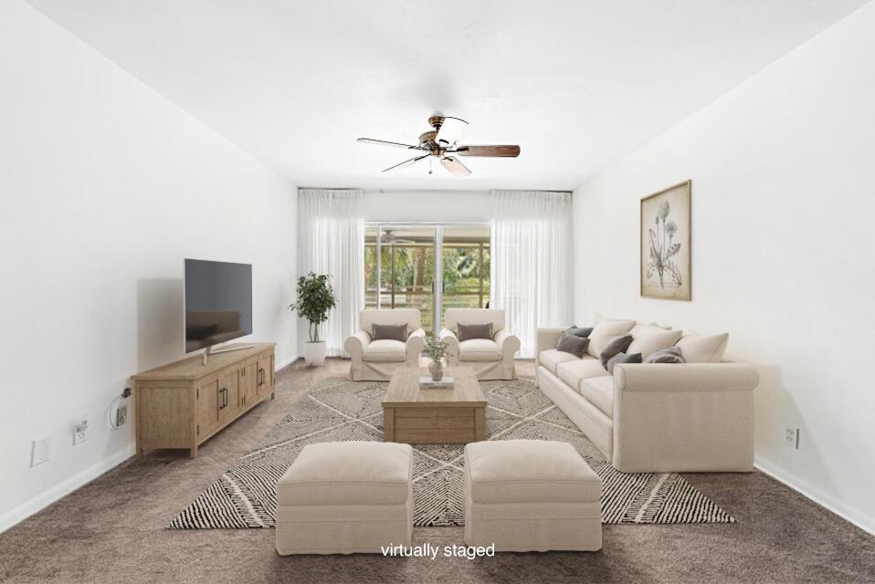 This virtually staged living room features a neutral sofa, two armchairs, ottomans, and carpeted flooring — 2 Garden Street # 203m, Tequesta FL 33469, TEQUESTA, FL