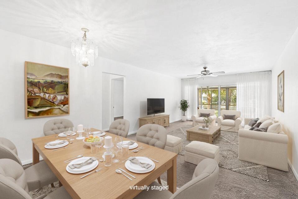 This virtually staged living and dining room features white walls, carpeted floors, and a chandelier — 2 Garden Street # 203m, Tequesta FL 33469, TEQUESTA, FL