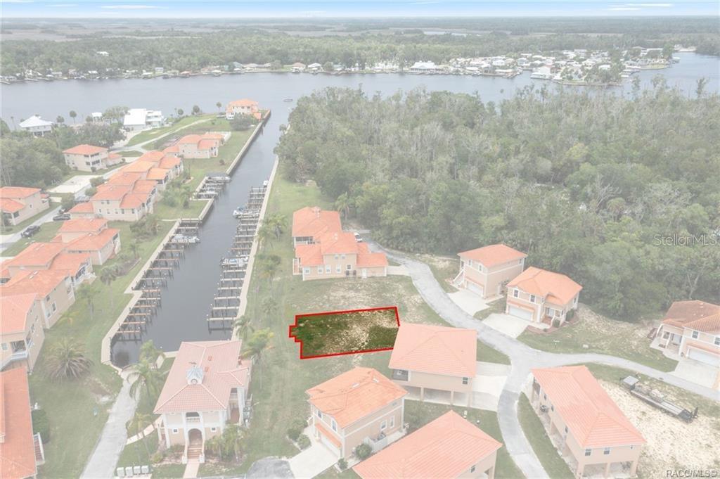 An aerial view shows a vacant residential lot outlined in red within a waterfront community — 4794 S POLDERLAND WAY, HOMOSASSA, FL