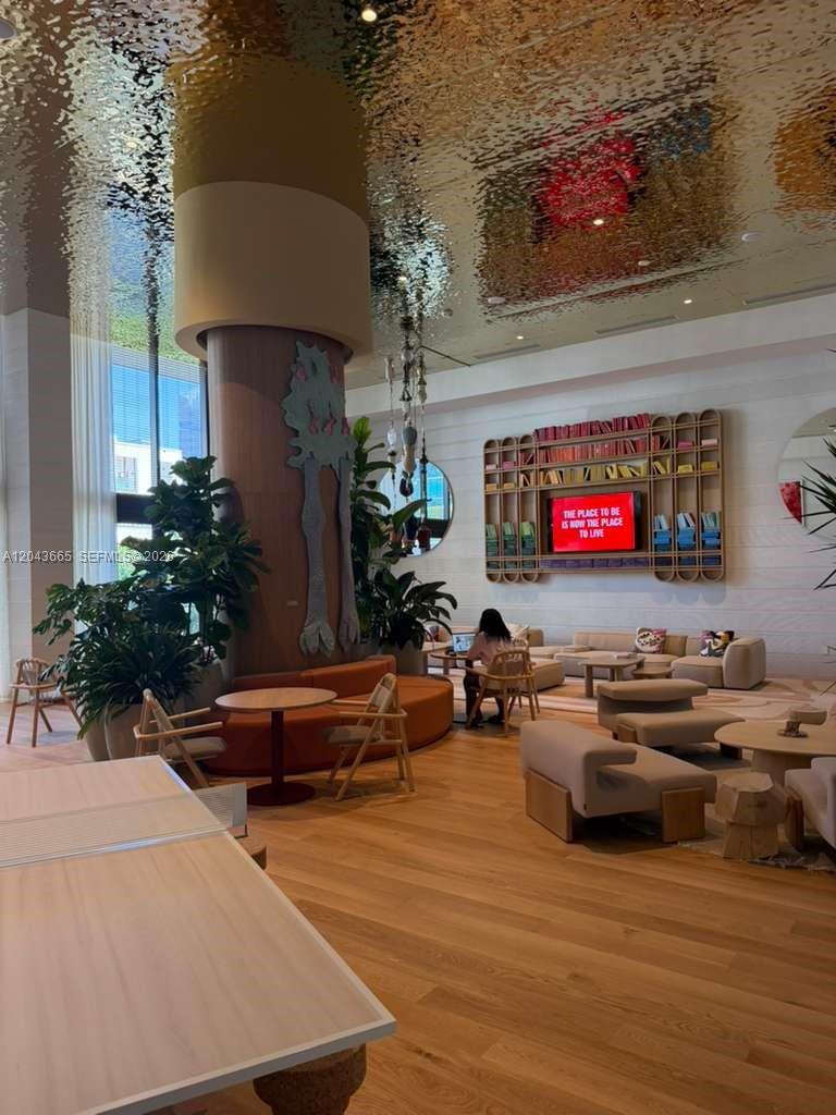 A modern lobby features a reflective ceiling, a large central pillar, and contemporary lounge seating — 3100 1st # 515, Miami FL 33137, MIAMI, FL