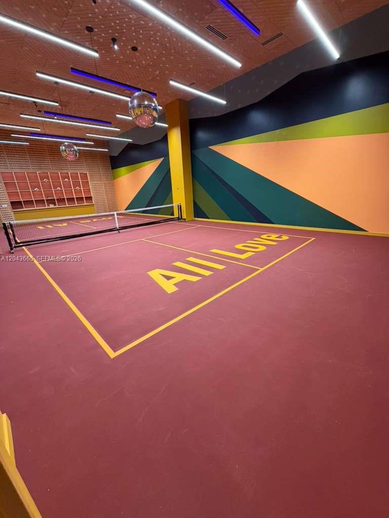 An indoor pickleball court features a maroon floor with yellow lines and geometric wall murals — 3100 1st # 515, Miami FL 33137, MIAMI, FL