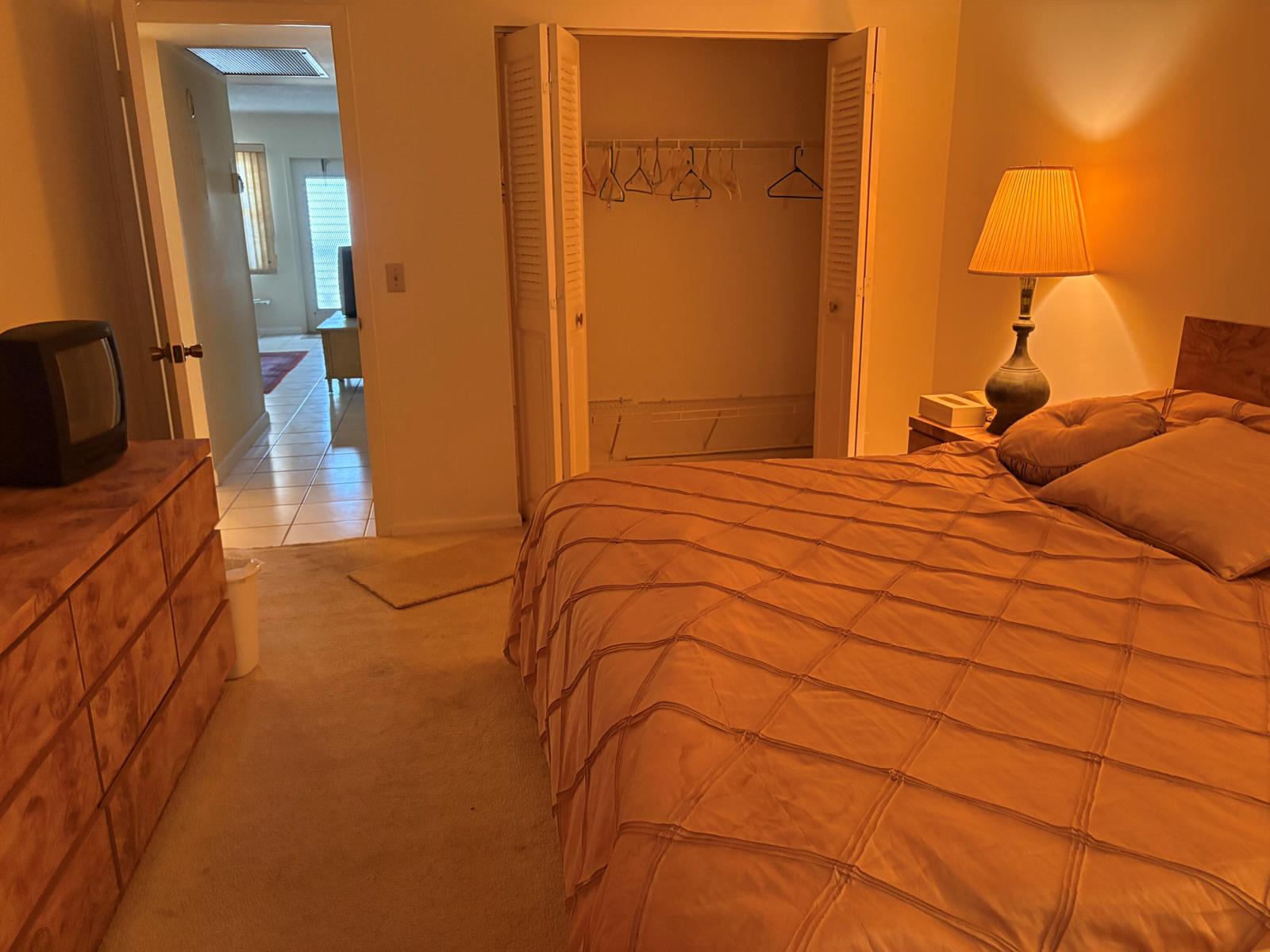 A bedroom with a bed, dresser, closet, and an open doorway leading to another room — 2036 Cornwall B # 2036, Boca Raton FL 33434, BOCA RATON, FL