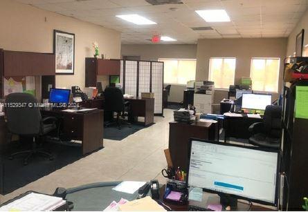 An office space featuring multiple desks, computer workstations, and a room divider — 3300 NW 112th Ave # 13, Doral FL 33172, DORAL, FL