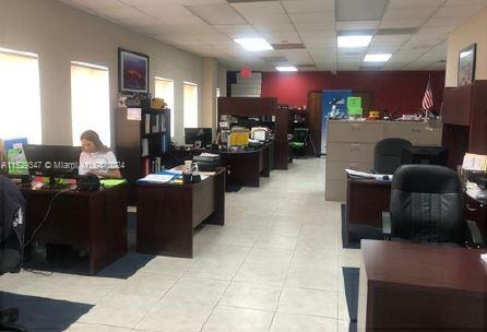 An office space features multiple desks, computer workstations, and filing cabinets on a tiled floor — 3300 NW 112th Ave # 13, Doral FL 33172, DORAL, FL