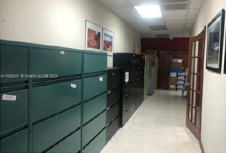 A narrow office hallway features rows of green and black metal filing cabinets — 3300 NW 112th Ave # 13, Doral FL 33172, DORAL, FL