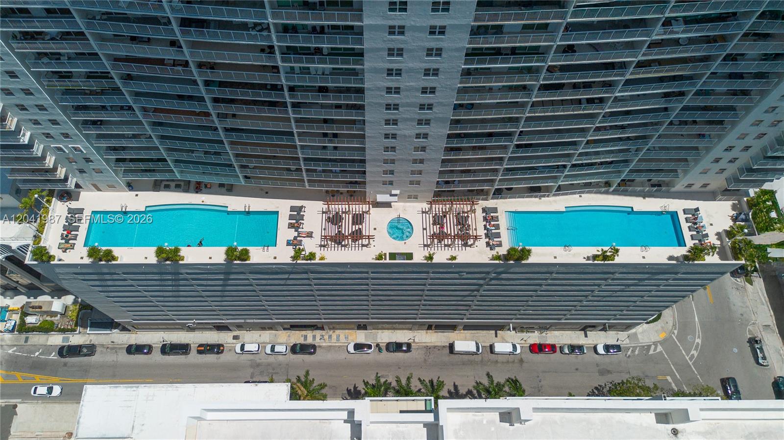 An aerial view shows a high-rise building with two rooftop swimming pools and a hot tub — 1200 Brickell Bay Dr # 4121, Miami FL 33131, MIAMI, FL