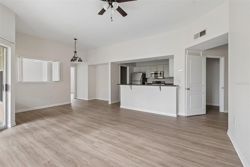 A kitchen with dark granite countertops, stainless steel appliances, and white cabinets — 5125 PALM SPRINGS BOULEVARD UNIT 4305, TAMPA, FL