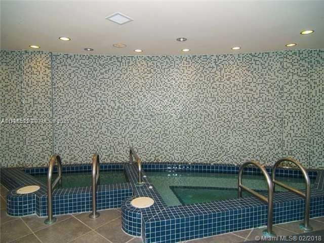 A tiled indoor spa area features two small pools with metal handrails and mosaic walls — 244 Biscayne Blvd # 3004, Miami FL 33132, MIAMI, FL