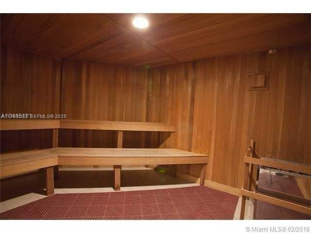 A wood-paneled sauna room features tiered wooden benches and a small heater — 244 Biscayne Blvd # 3004, Miami FL 33132, MIAMI, FL