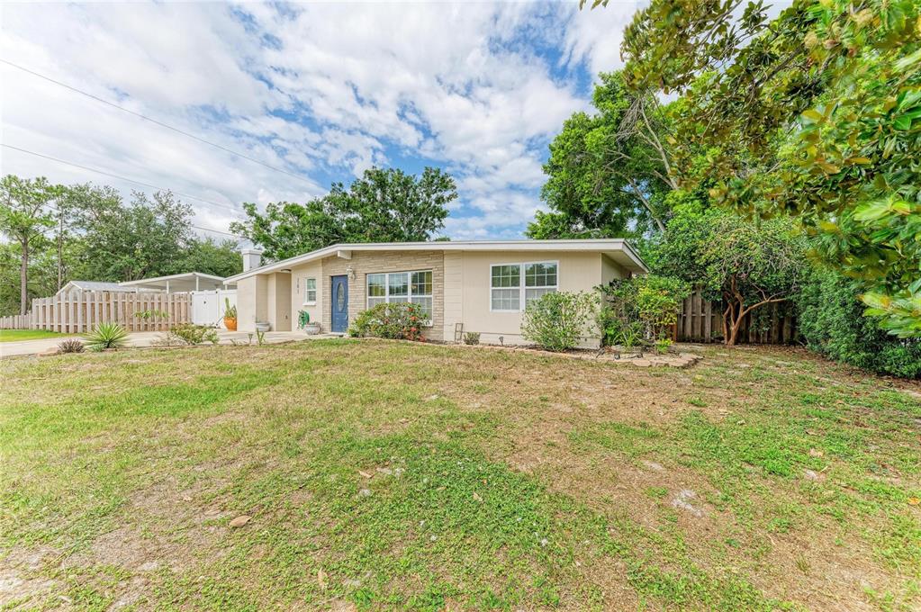 A single-story house with a light-colored exterior, stone accents, and a blue front door — 161 SUNTAN AVENUE, SARASOTA, FL