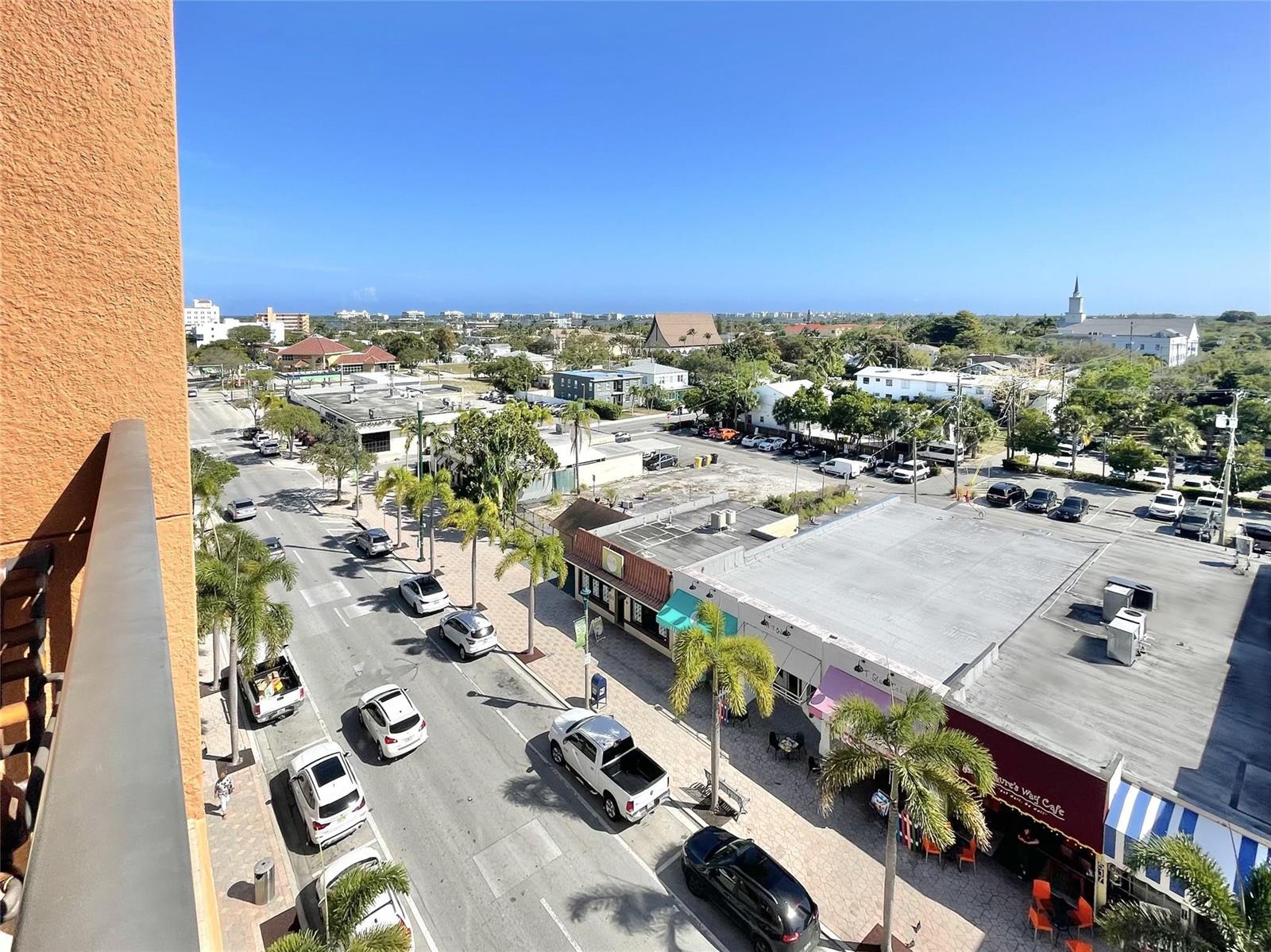 An elevated view of a street with parked cars, palm trees, and surrounding buildings — 511 Lucerne Avenue # 616, FL 33460, FL