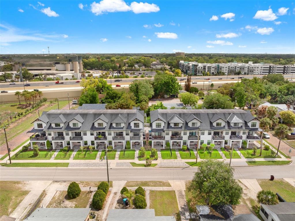 An aerial view of a multi-unit townhouse complex situated next to a highway — 1250 FORMOSA AVENUE, WINTER PARK, FL