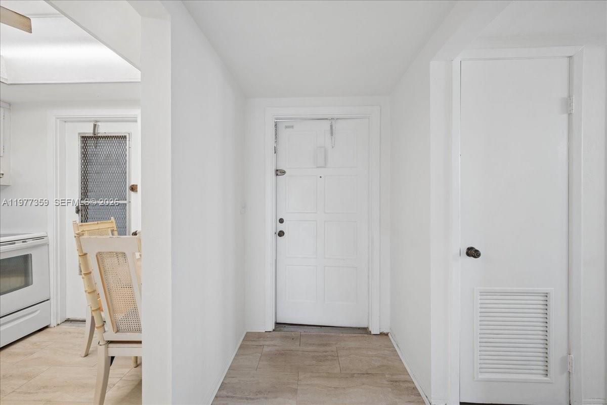 An interior view shows a white front door, a side door, and a closet door — 1200 Hillcrest Ct # 315, Hollywood FL 33021, HOLLYWOOD, FL
