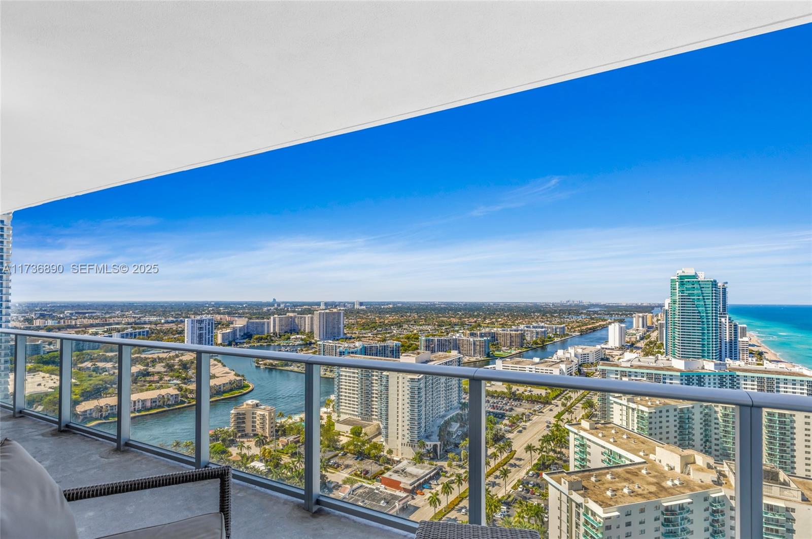 A high-rise balcony overlooks a coastal city, a waterway, and the ocean — 4111 S Ocean Dr # 2904, Hollywood FL 33019, HOLLYWOOD, FL