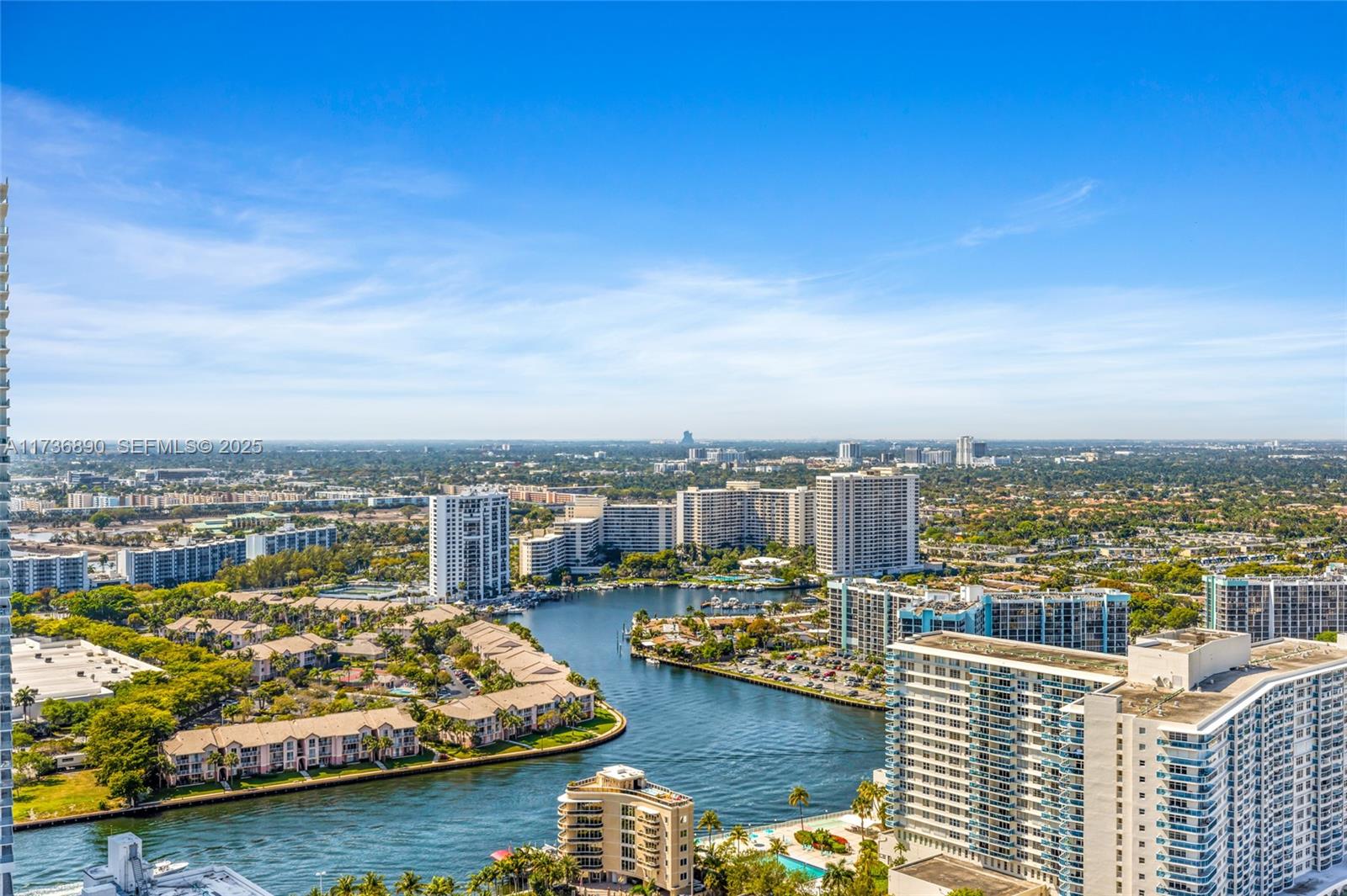 An aerial view shows a waterway winding through a dense residential area with high-rise buildings — 4111 S Ocean Dr # 2904, Hollywood FL 33019, HOLLYWOOD, FL