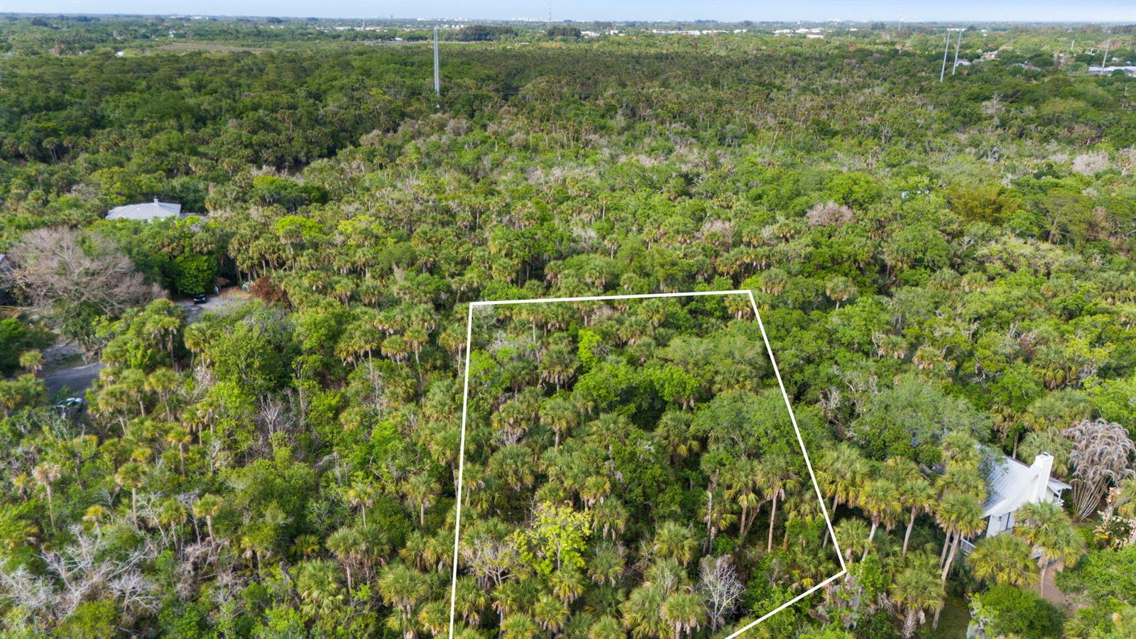 An aerial view shows a rectangular plot of land outlined in white amidst dense vegetation — Tbd Old River Road, Fort Pierce FL 34982, FORT PIERCE, FL