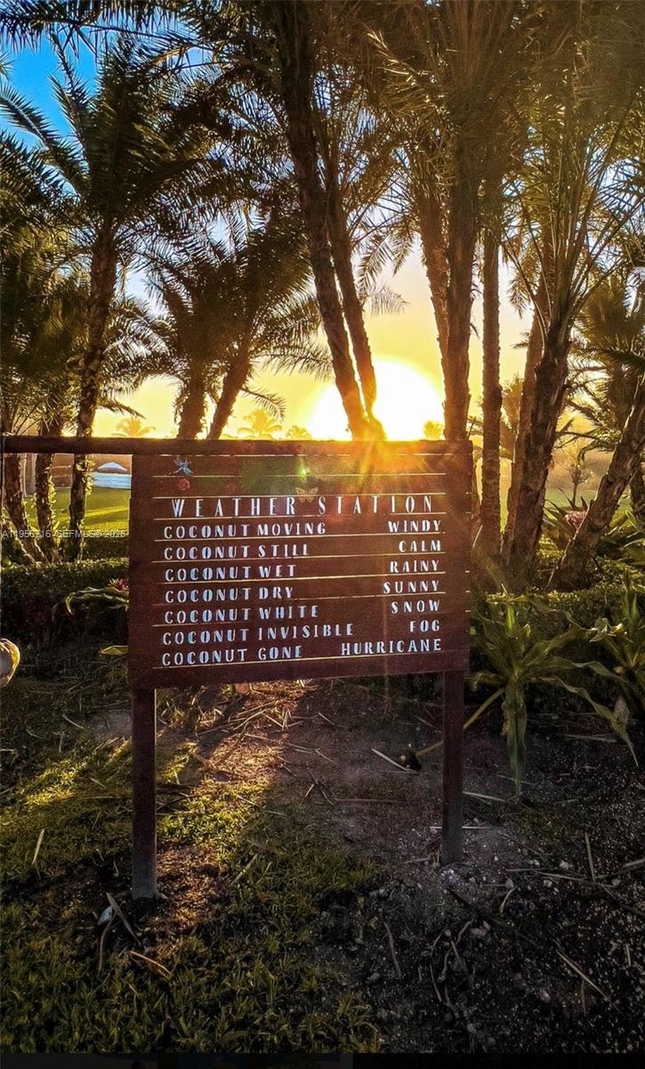 A wooden weather station sign stands outdoors in a palm tree grove at sunset — 14949 SW 184th Ave, Miami FL 33196, MIAMI, FL