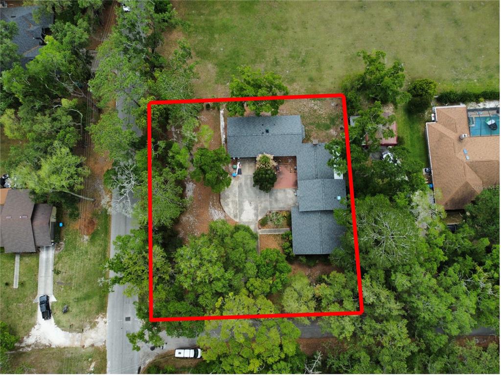 An aerial view shows a house with a gray shingled roof and a concrete driveway — 18784 NW 230TH STREET, HIGH SPRINGS, FL