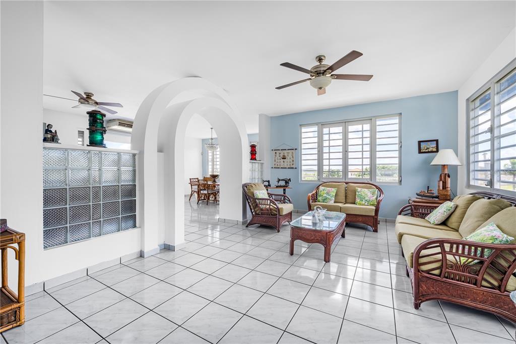 A living room features white tile floors, an arched entryway, and wicker furniture — SR 307 KM 7.0 VISTAMAR ST ESTANCIAS DE ALTA VISTA, BOQUERON, PR