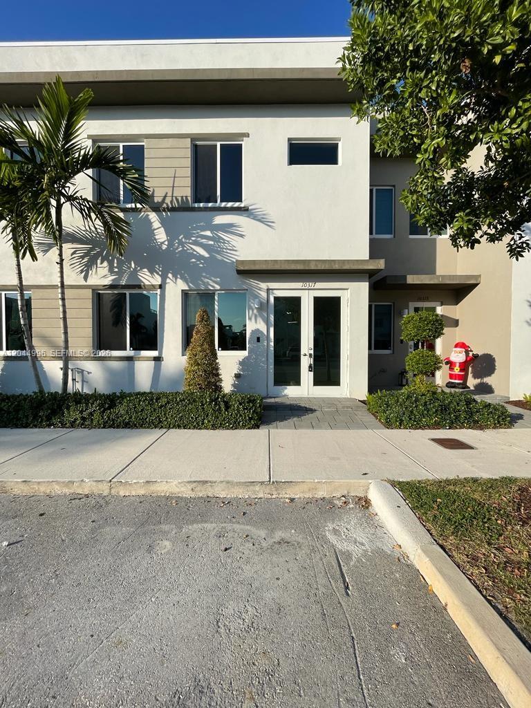 A two-story building exterior features a double-door entrance, large windows, and a small palm tree — 10317 NW 66th St # 10317, Doral FL 33178, DORAL, FL