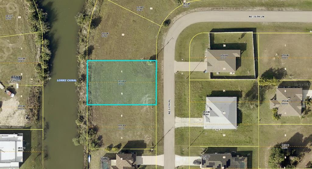 This is an aerial map showing a vacant residential lot highlighted in blue along a canal — 3624 NE 17TH PLACE, CAPE CORAL, FL