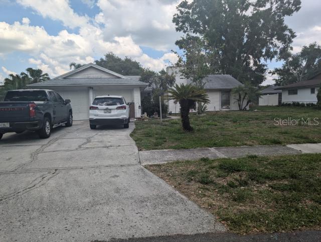 A single-story house with a two-car garage, a concrete driveway, and a front yard — 4345 OLD COLONY ROAD, MULBERRY, FL