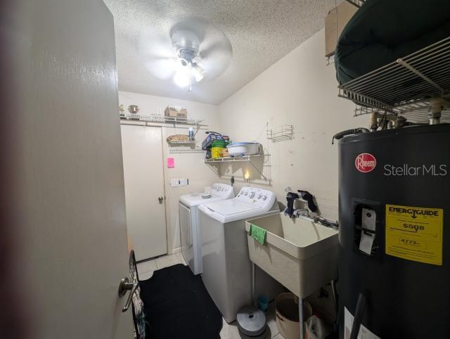 A laundry room features a washer, dryer, utility sink, and a water heater — 4345 OLD COLONY ROAD, MULBERRY, FL