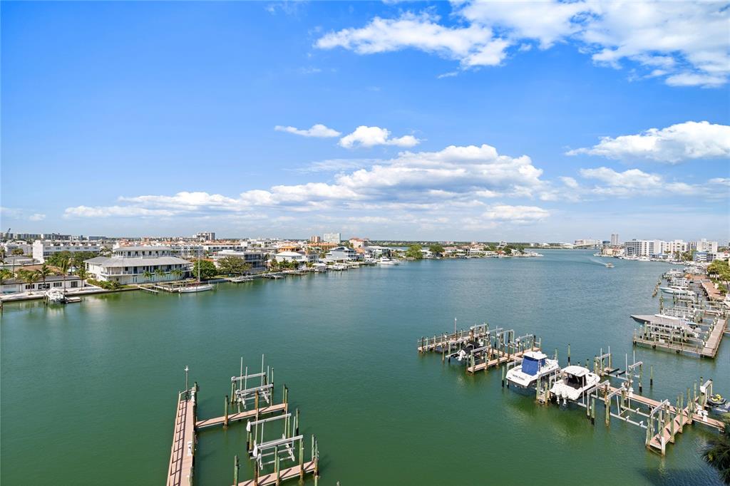 An elevated view of a coastal waterway featuring multiple boat docks and residential buildings — 530 S GULFVIEW BOULEVARD UNIT 601, CLEARWATER BEACH, FL