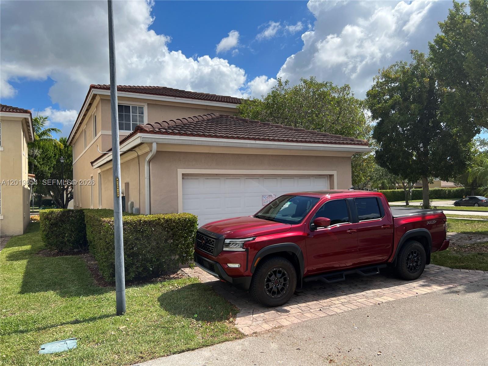 A red pickup truck is parked in the driveway of a two-story suburban house — 14008 SW 274 TER, Homestead FL 33032, HOMESTEAD, FL
