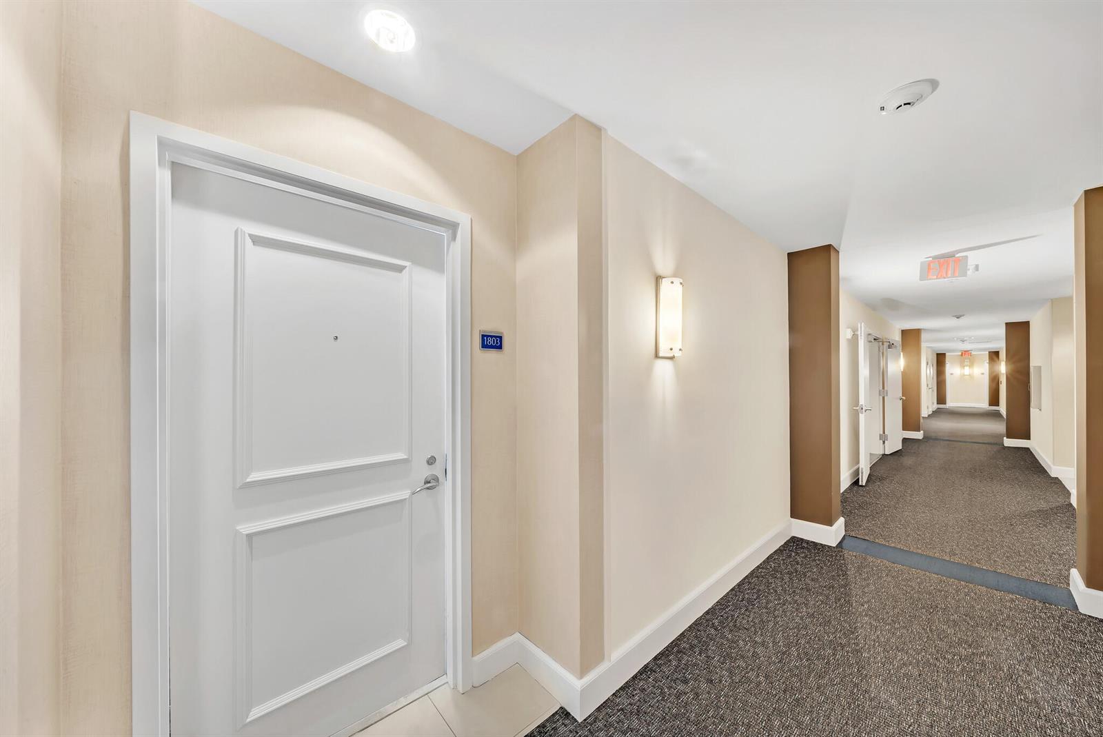 A white door with room number 1803 sits in a carpeted apartment building hallway — 1945 S Ocean Drive # 1803, Hallandale Beach FL 33009, HALLANDALE BEACH, FL