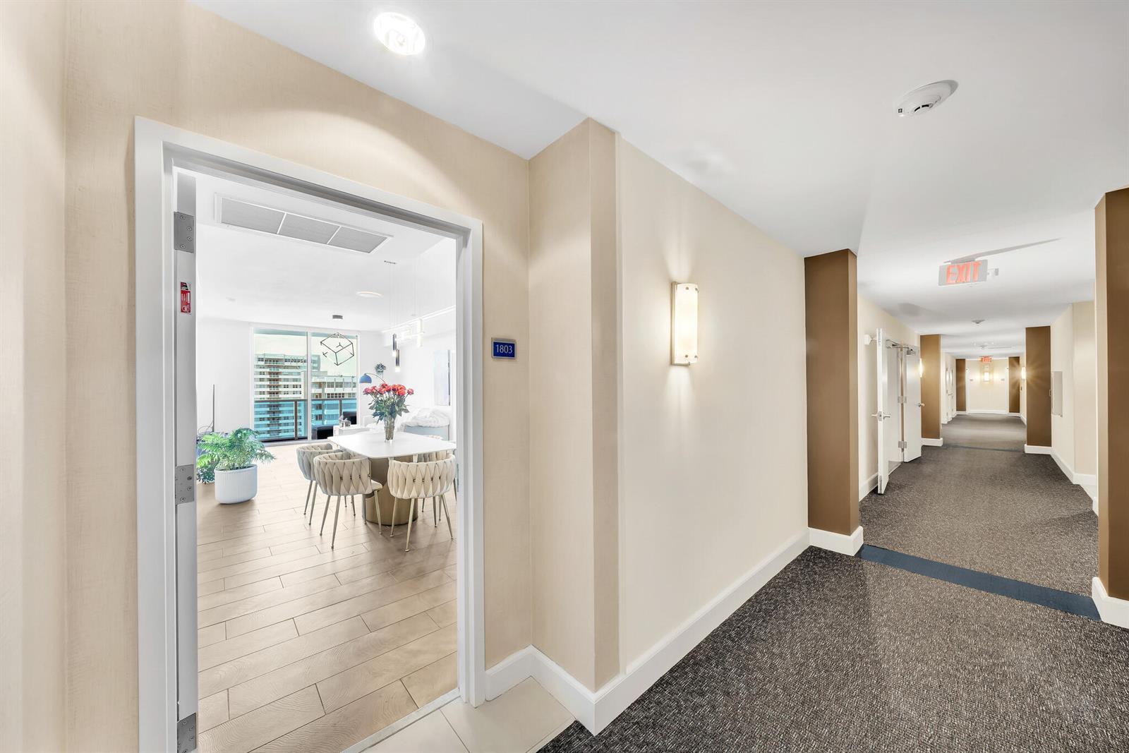 A view from a carpeted hallway into a modern apartment with light wood-look flooring — 1945 S Ocean Drive # 1803, Hallandale Beach FL 33009, HALLANDALE BEACH, FL