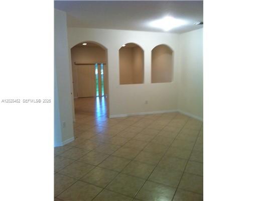 An interior view shows a tiled living area with two doors and a staircase — 13147 SW 42nd St # 6103, Miramar FL 33027, MIRAMAR, FL