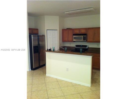 An interior view of a room with tiled floors and two arched wall niches — 13147 SW 42nd St # 6103, Miramar FL 33027, MIRAMAR, FL