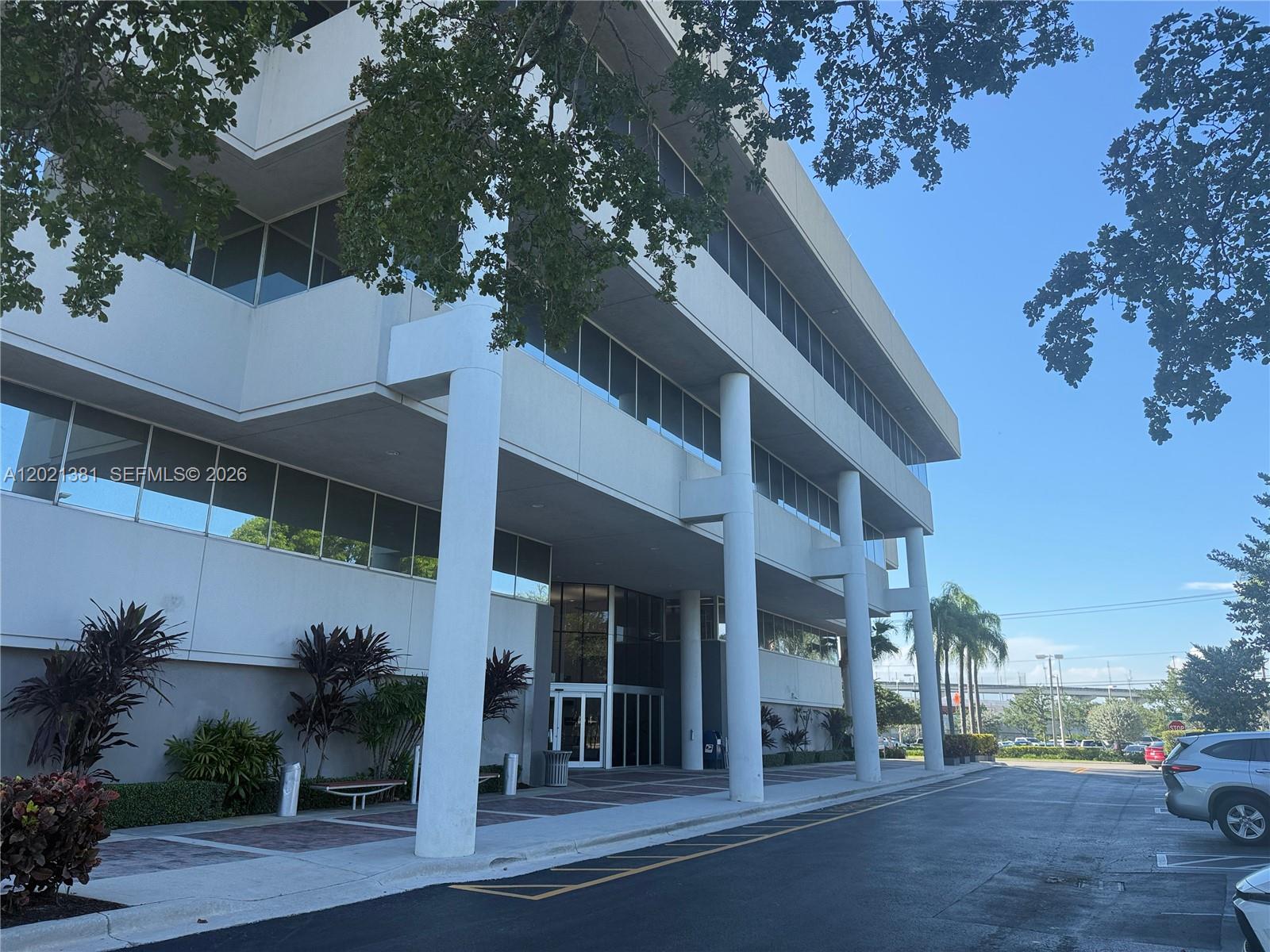 A multi-story office building features a covered entrance supported by large white columns — 290 NW 165th St # M500, Miami FL 33169, MIAMI, FL
