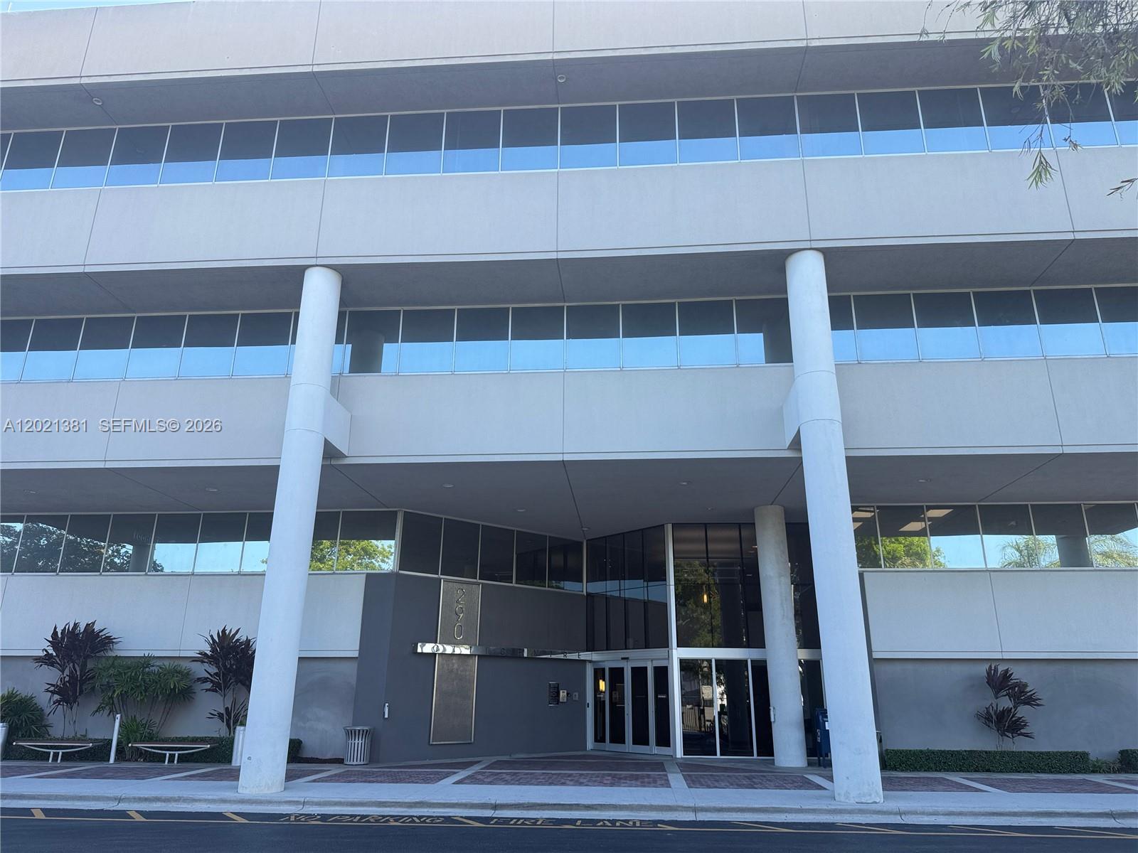 A multi-story commercial office building features a glass entrance and two prominent white support columns — 290 NW 165th St # M500, Miami FL 33169, MIAMI, FL