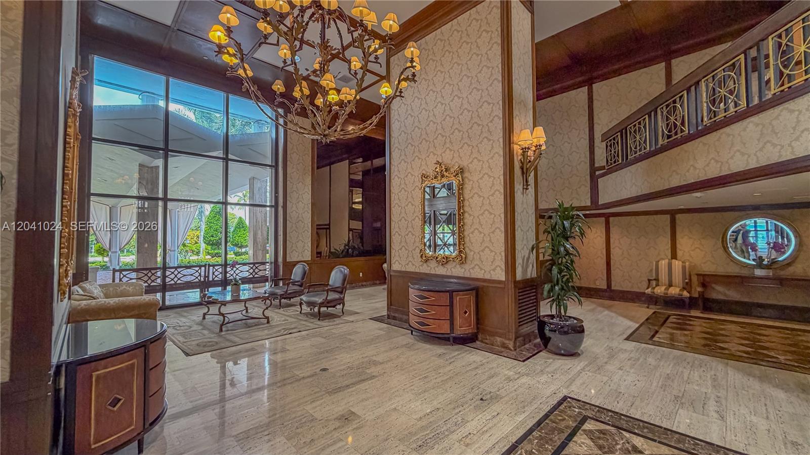 A grand hotel lobby features a large chandelier, marble floors, and floor-to-ceiling windows — 9801 Collins Ave # 3U, Bal Harbour FL 33154, BAL HARBOUR, FL