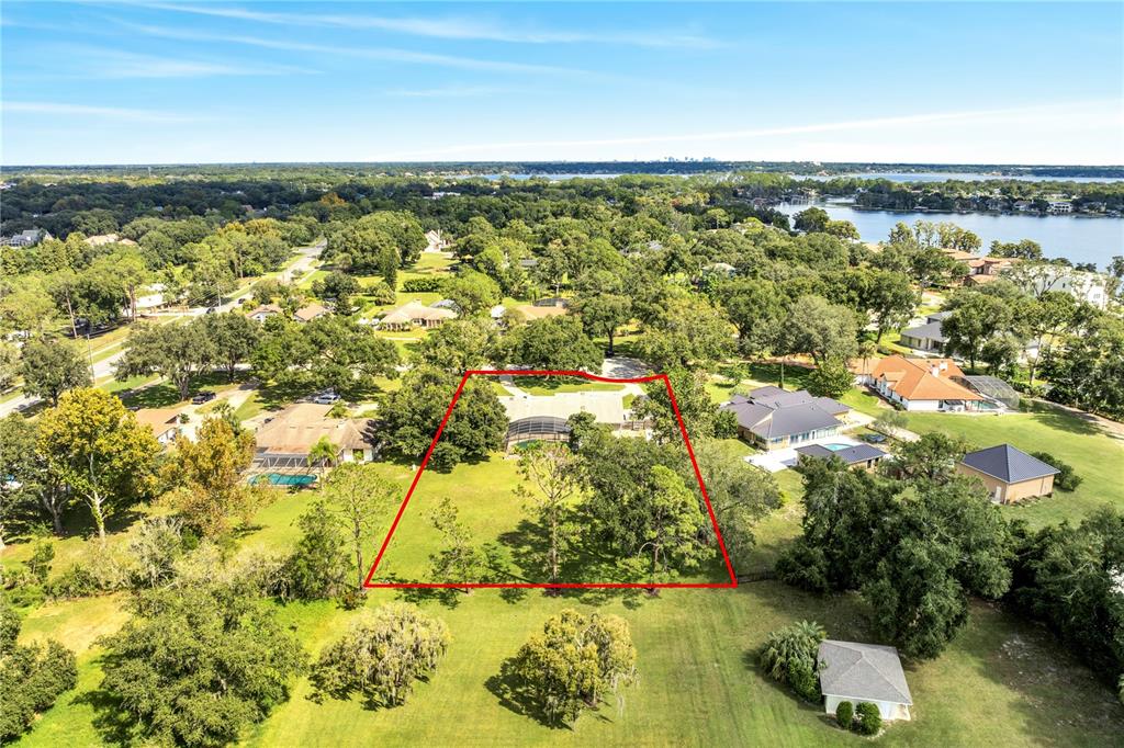 An aerial view shows a residential property with a screened pool and large grassy yard — 3328 WAX BERRY COURT, WINDERMERE, FL