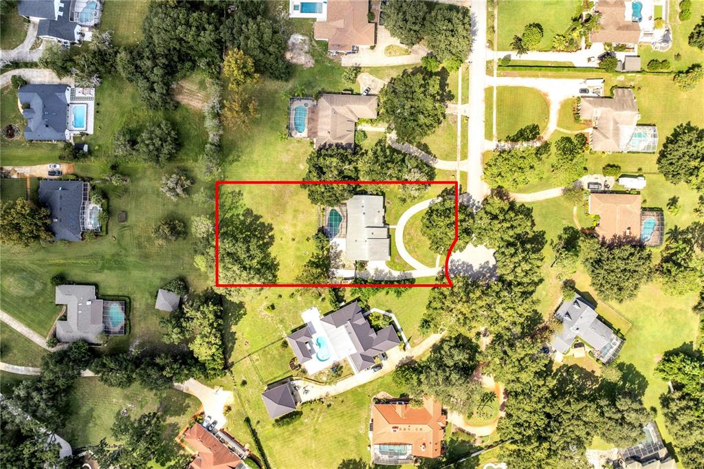 An aerial view shows a residential property with a house, pool, and trees — 3328 WAX BERRY COURT, WINDERMERE, FL