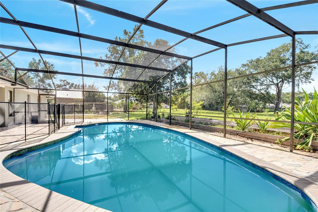 An aerial view shows several houses with swimming pools surrounded by trees and a lake — 3328 WAX BERRY COURT, WINDERMERE, FL