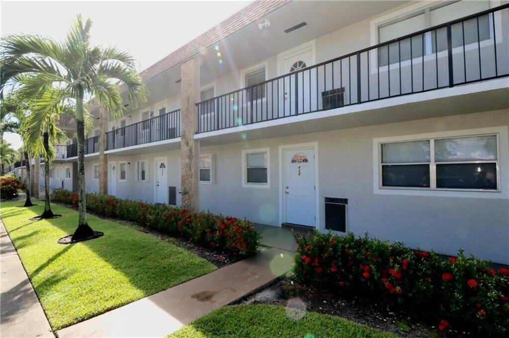 A two-story apartment building exterior with palm trees, landscaping, and a second-floor balcony — 9915 Sandalfoot Boulevard # 408, Boca Raton FL 33428, BOCA RATON, FL